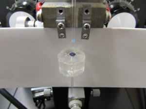 The setup prior to gluing of the capillary. The white paper is just to help for contrast.