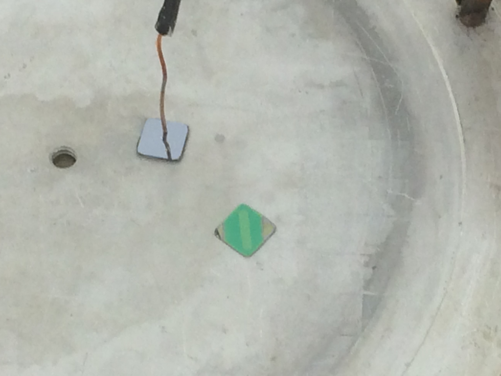 500 nm of pyrex on an oxide spacer, and a pyrex spacer being bonded to a nitride flowchip. The channel height (~100 nm) is maintained from the evaporation.
